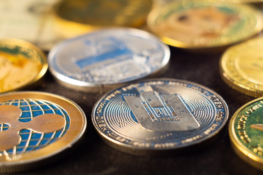 加密貨幣交易策略:開戶比較與CFD開戶深度解析 closeup shot of many shiny cryptocurrency coins 2023 11 27 05 36 54 utc 加密貨幣